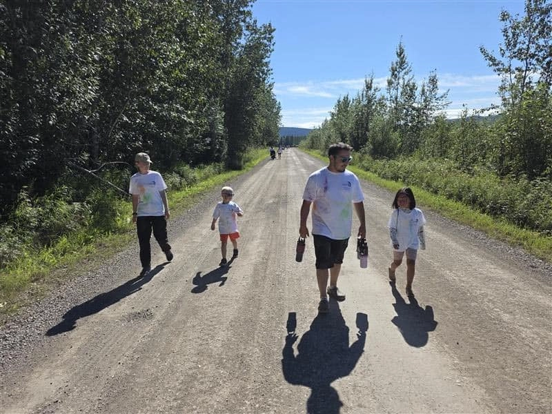 Participants running along the airport runway course